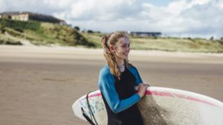Female surfer on beach