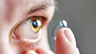 Putting in a contact lens