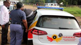 Members of the Hawks unit make an arrest with a branded police car