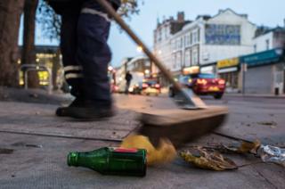 A brush sweeps the street