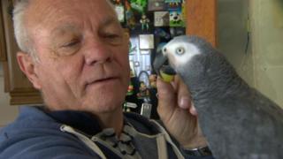 Patrick Doherty at home with his parrot