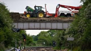 The tractor on the damaged bridge