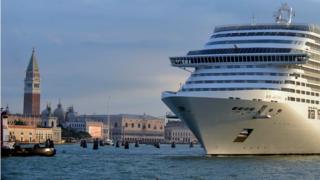 A giant cruise ship arrives in front of Saint-Mark's square in Venice on September 21, 2013