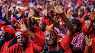 Mourners and supporters of the Movement for Democratic Change (MDC) party wave good bye to Zimbabwe's iconic opposition leader Morgan Tsvangirai who died last week after a battle with cancer, on February 20, 2018, during his burial at his rural village Humanikwa in Buhera.