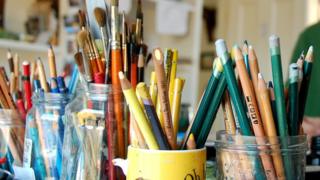 Paint brushes and colouring pencils