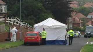 The body was found on Greenfield Road in the early hours of Wednesday