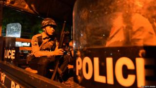 A Myanmar riot policemen sits in a truck on a street in Yangon's Mingalar Taung Nyunt township early on May 10, 2017