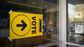 A sign indicating the way to the polling station in Toronto