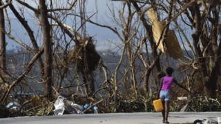 A girl carries water in Port-Salut, southwest of Port-au-Prince, in Haiti, on October 9, 2016