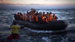 Refugees and migrants arrive on a dinghy from the Turkish coast to the Greek island of Lesbos. 18 Dec 2015