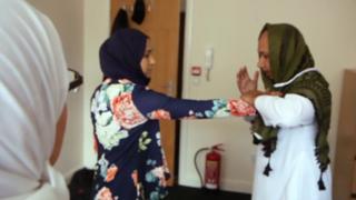 Two people practise self defence