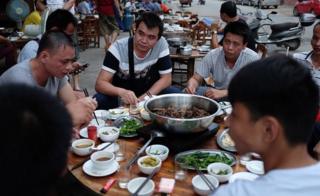 This photo taken on May 9, 2016 shows people eating dog meat at a restaurant in Yulin, in China's southern Guangxi region.