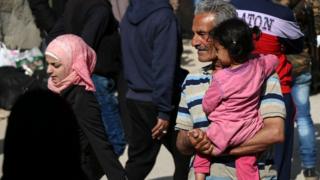 People wait to leave the rebel-held Barzeh district of Damascus (8 May 2017)
