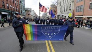 OutVets marching with rainbow flag