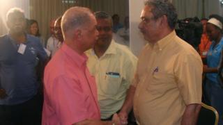 Seychellois President James Michel (L) congratulates Seychellois Democratic Alliance (known by its creole acronym LDS) leader Roger Mancienne in victoria on September 11, 2016.
