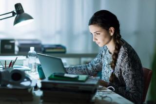 A woman works and studies at the same time