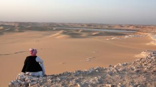 A man looking out over the land near Siwa