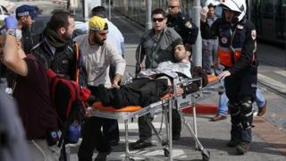 Wounded Israeli guard wheeled on a stretcher (10/11/15)