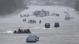 An image showing residents waiting to be rescued from the flood waters of Tropical Storm Harvey