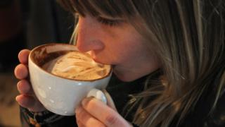 Woman drinking a cappuccino in Berlin, 24 Jan 11
