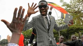 Robert Kyagulani, commonly known as Bobi Wine waves to his supporters moments after being sworn in as a Ugandan Member of Parliament on 11 July 2017.