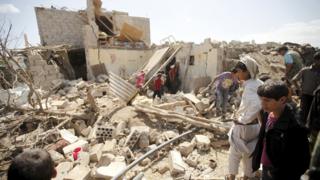 People inspect damage at a house after it was destroyed by a Saudi-led air strike in Yemen"s capital Sanaa, February 25, 2016.