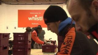 Workers in a Whistl sorting room