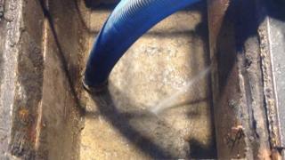 NI Water crews are clearing the sewer by using hoses and spades to break up the fatberg