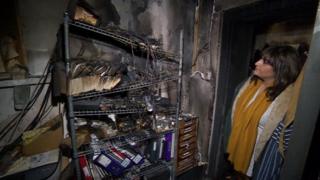 Restaurant owner Shaima Swift examining the damage