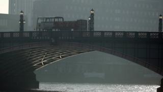 Buses on Lambeth Bridge with polluted air visible in the background