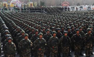Paramilitary policemen stand in formation as they take part in an anti-terrorism oath-taking rally, in Kashgar, Xinjiang Uighur Autonomous Region, China, 27 February 2017.