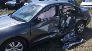Picture of the damaged car after it was hit by a truck
