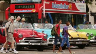 Tourists and vintage American cars in old Havana, 2015