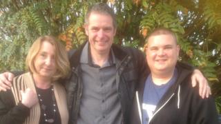 Ryk Downes with his two rescuers