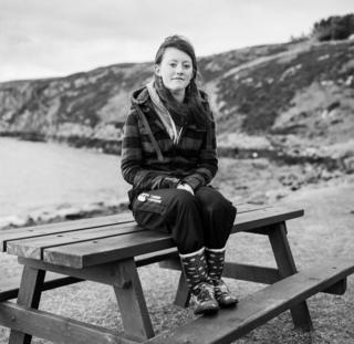 A girl sits on a bench