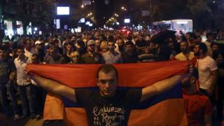 Anti-government protesters, supporters of the armed group who have been holed inside a police station, prepare to march in Yerevan, Armenia, Saturday, July 30, 2016