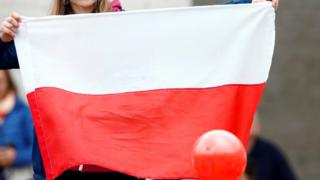 Woman holding a Polish flag