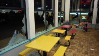 A fast food restaurant with smashed windows