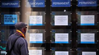 A man looks at job adverts