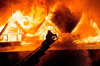 A firefighter extinguishes a fire at Kandawgyi Palace hotel in Yangon early on 19 October 2017