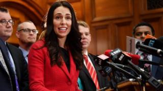 New leader of the Labour Party Jacinda Ardern (C) speaks with her front bench at her first press conference at Parliament in Wellington on August 1, 2017