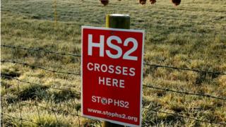 A poster protesting against a proposed high speed rail project linking London with northern England (HS2) is nailed to a fence on a field near Lymm, northern England
