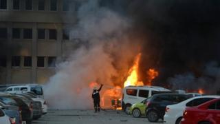 Cars burning outside governor's office, Adana