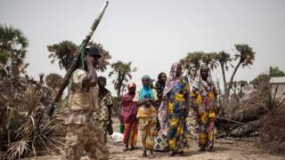 A Nigerian soldier, with a rocket propelled grenade (RPG), patrols on the outskirt of the town of Damasak in North East Nigeria on April, 25 2017 as thousands of Nigerians, who were freed in 2016 by the Nigerian army from Boko Haram insurgents, are returning to their homes in Damasak