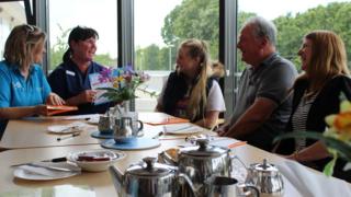 Chris Dunning, with his wife Teresa and daughter Laura, speaking to Tenovus cancer support advisor Rachael Sharples
