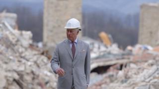 Prince Charles walks through Amatrice