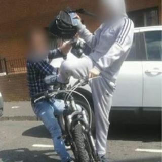 One of the tourists, pictured on the left, tried to grab the bag off the alleged thief