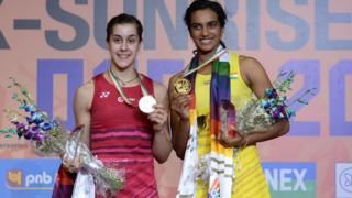 India's Pusarla V. Sindhu (R) poses with her gold medal, with Spain's Carolina Marin with her silver medal,