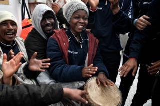 Migrants play music aboard MV Aquarius