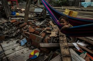 A child lies in a hammock